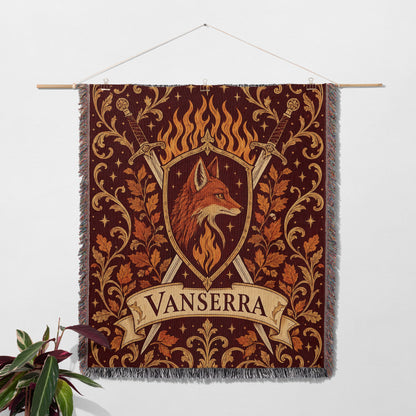 Vanserra Crest Woven Throw Blanket hanging on a wall with a plant