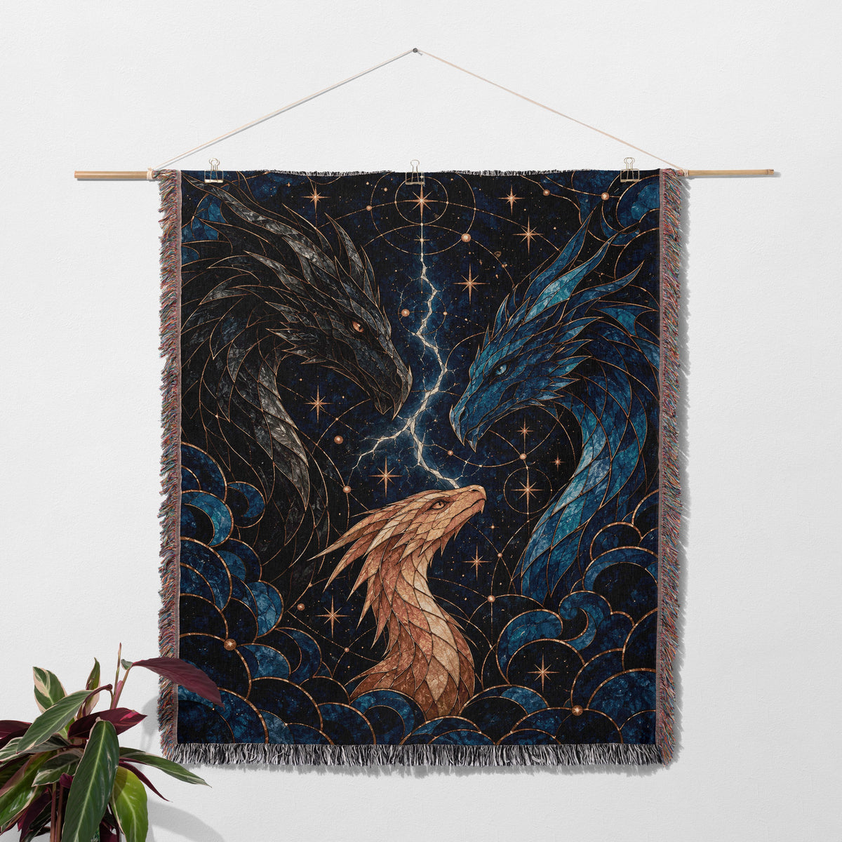 Dragon Bond Woven Throw Blanket hanging on a wall with a plant