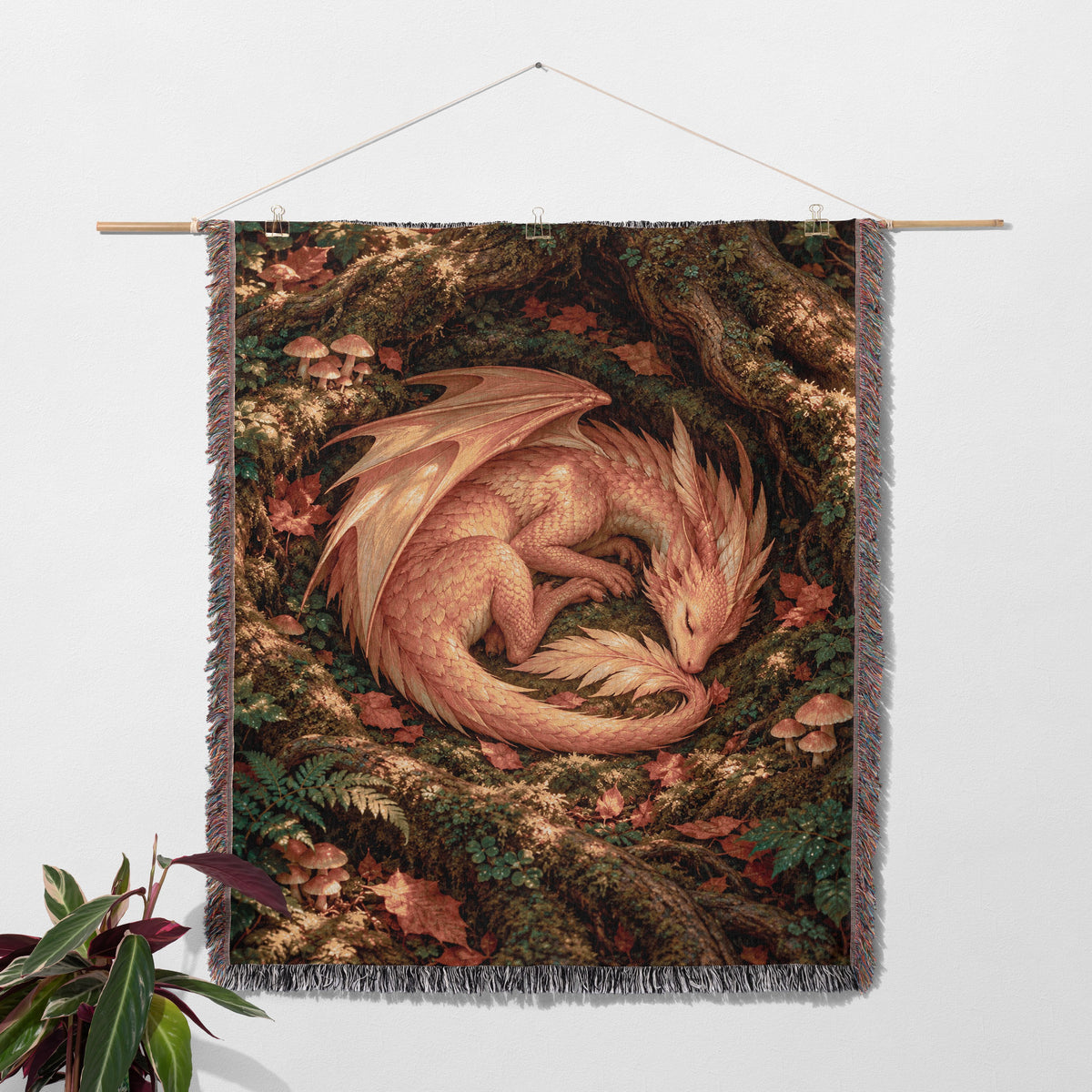 Golden Dragon Woven Throw Blanket hanging on a wall with a plant