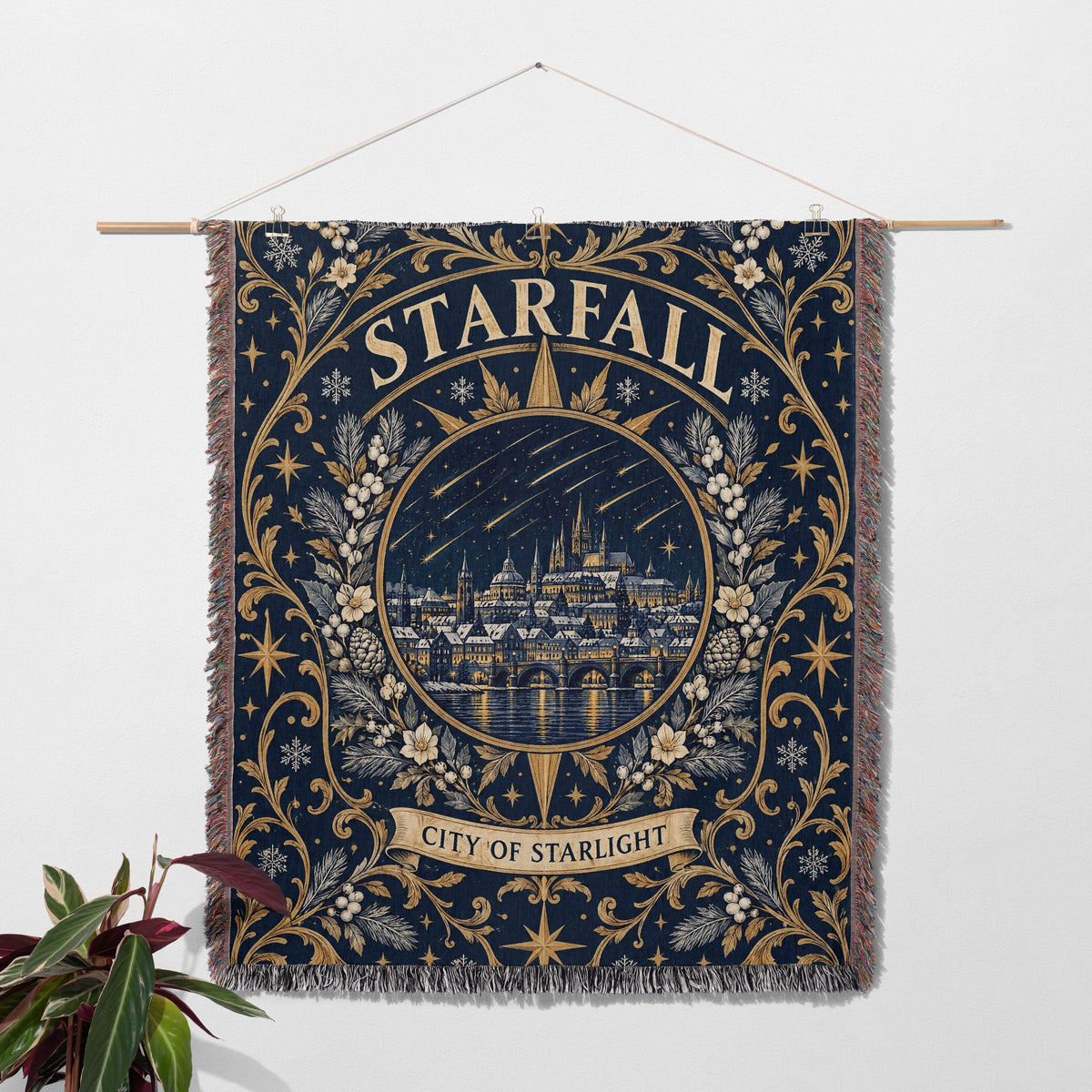Starfall City of Starlight Crest Woven Throw Blanket hanging on a wall with a plant