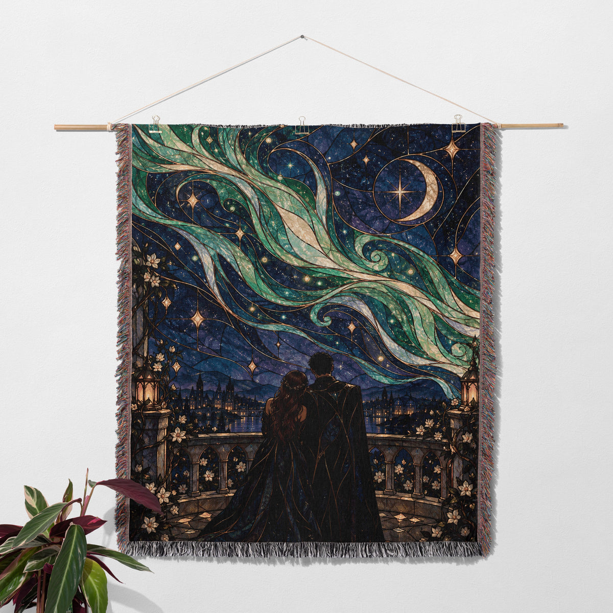 Starfall Stained Glass Woven Throw Blanket hanging on a wall with a plant