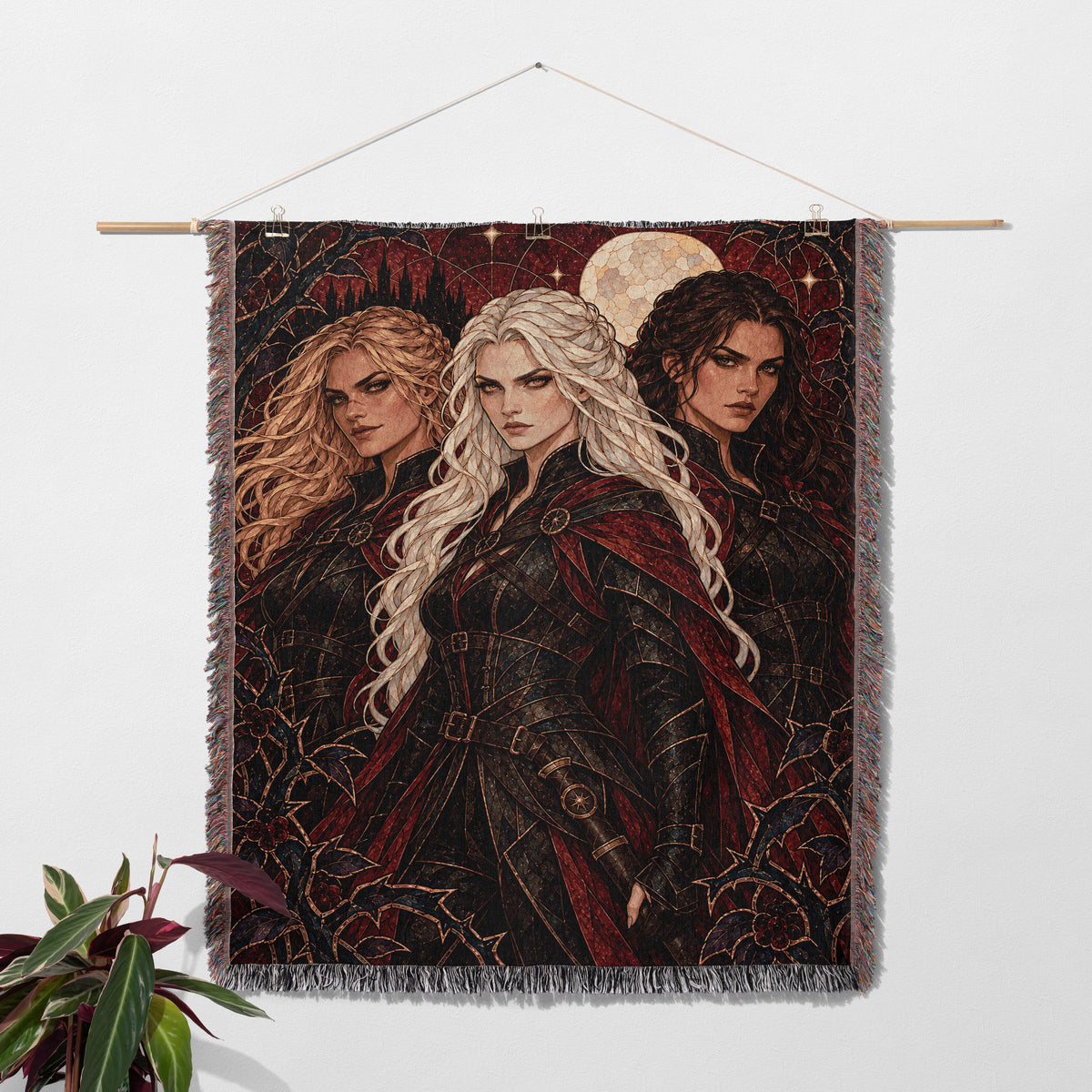 Ice, Fire, and Stone Woven Throw Blanket hanging on a wall with a plant