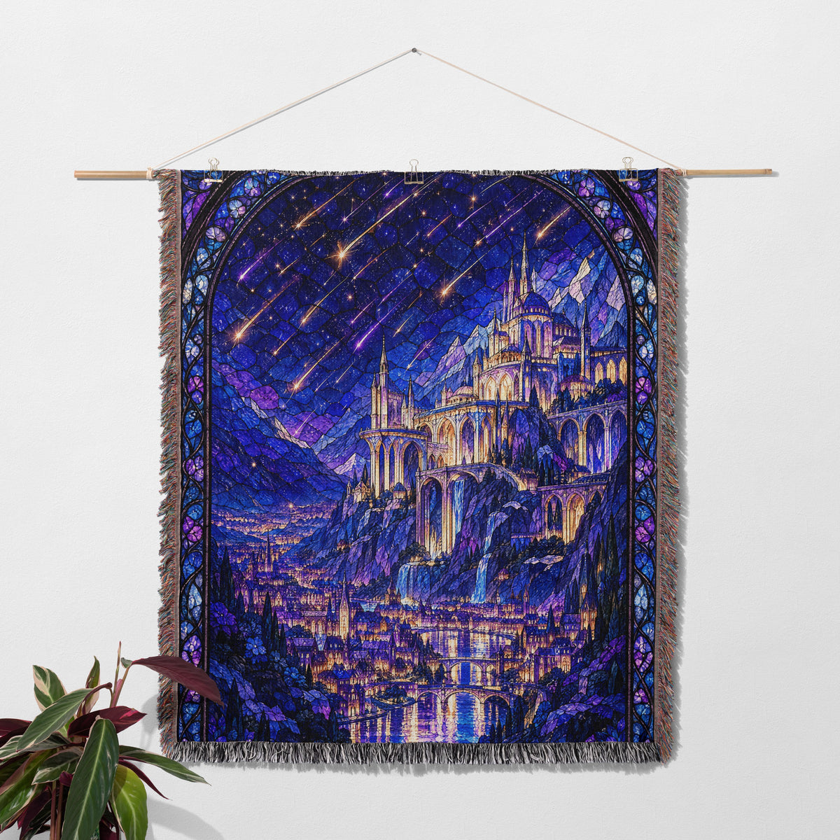 Starfall over Velaris Stained Glass Woven Throw Blanket hanging on a wall with a plant