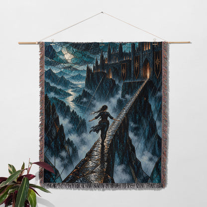 Parapet Woven Throw Blanket hanging on a wall with a plant