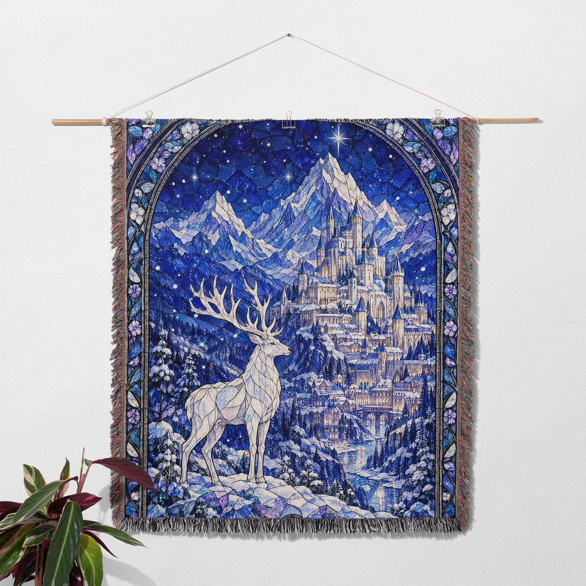 Orynth in Winter Stained Glass Woven Throw Blanket hanging on a wall with a plant