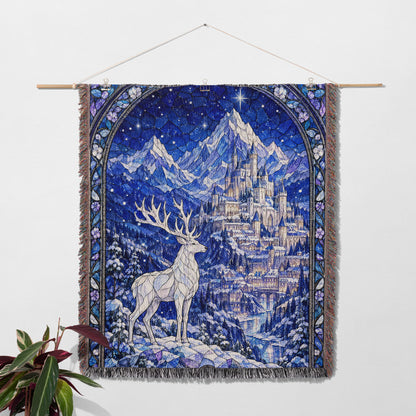 Orynth in Winter Stained Glass Woven Throw Blanket hanging on a wall with a plant