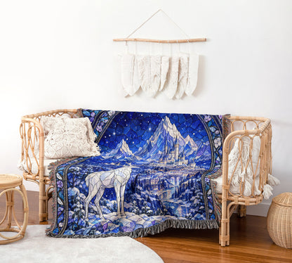 Orynth in Winter Stained Glass Woven Throw Blanket on a rattan chair