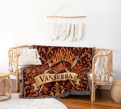 Vanserra Crest Woven Throw Blanket on a rattan chair