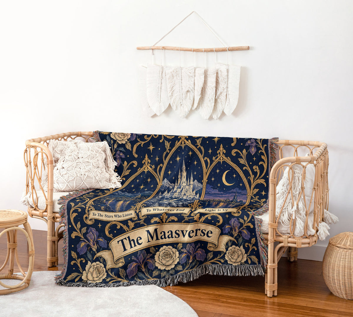Maasverse Three Realms Crest Woven Throw Blanket on a rattan chair