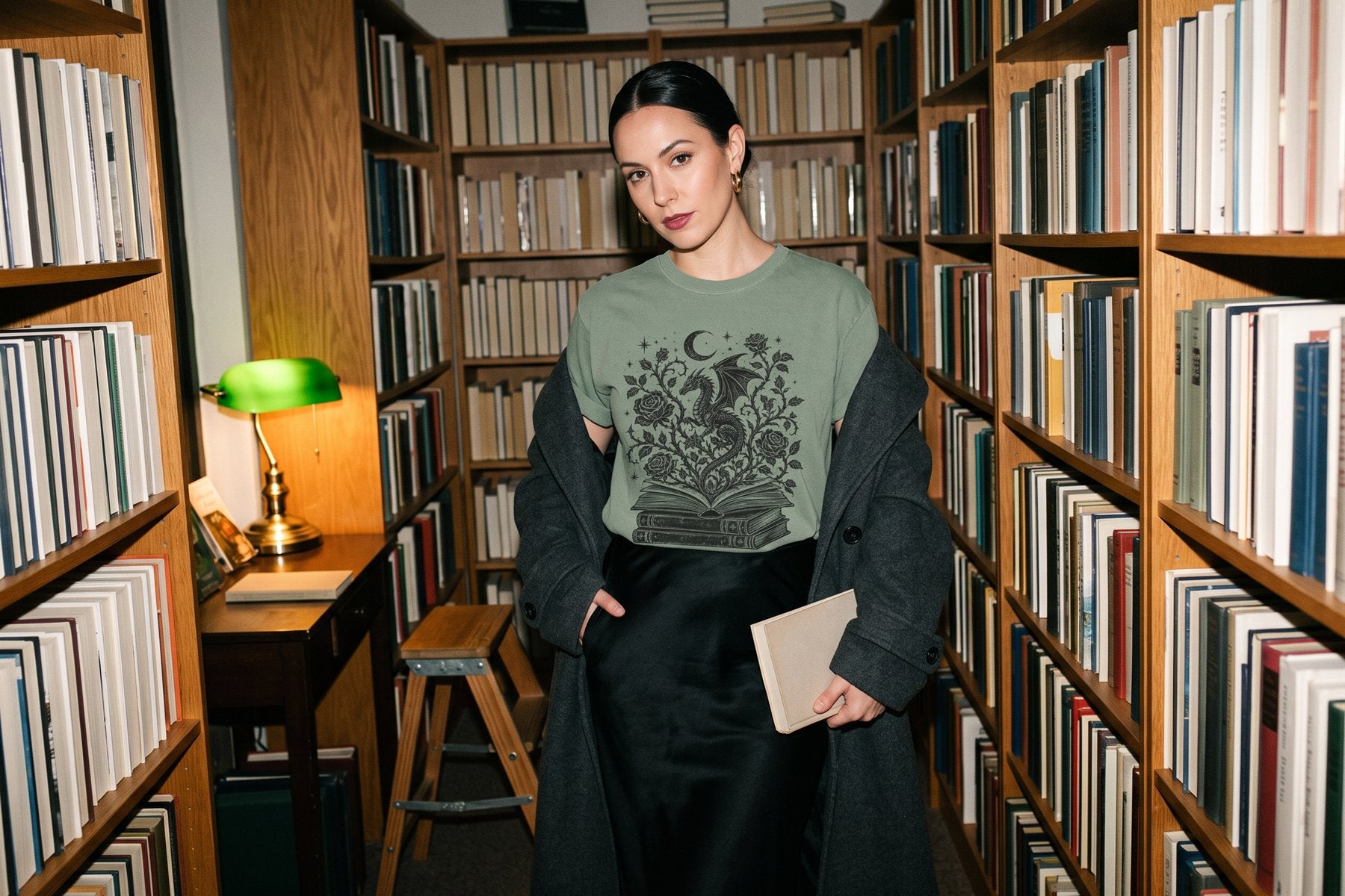 Reader in the Mystical Dragon tee in a bookshop aisle after closing